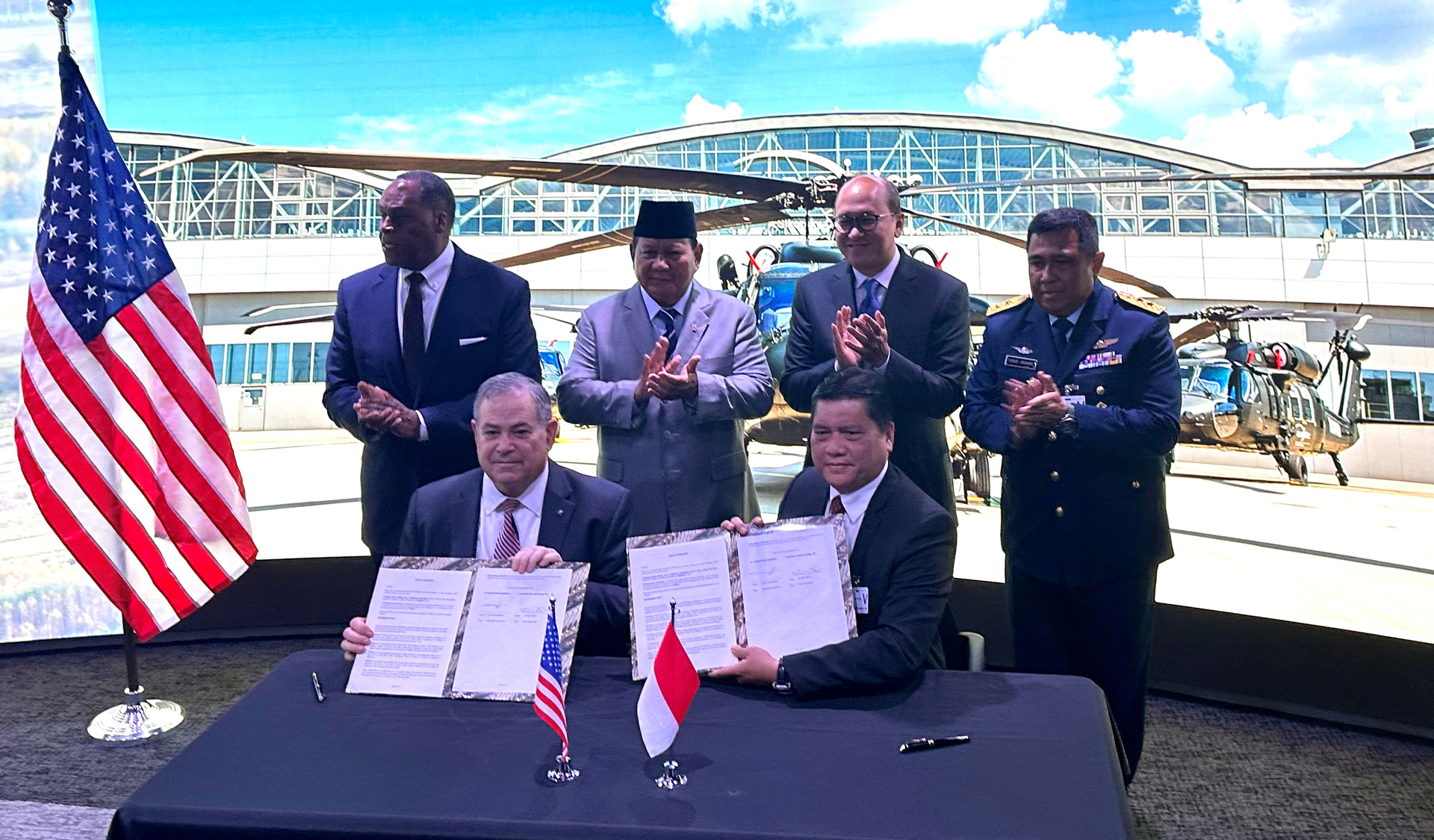 Sikorsky Vice President of Global Business Development Jeff White (seated left) and PTDI Chief Executive Officer Gita Amperiawan present a signed agreement for S-70M Black Hawk helicopters at Lockheed Martin offices in Washington, D.C., Aug. 22, 2023.