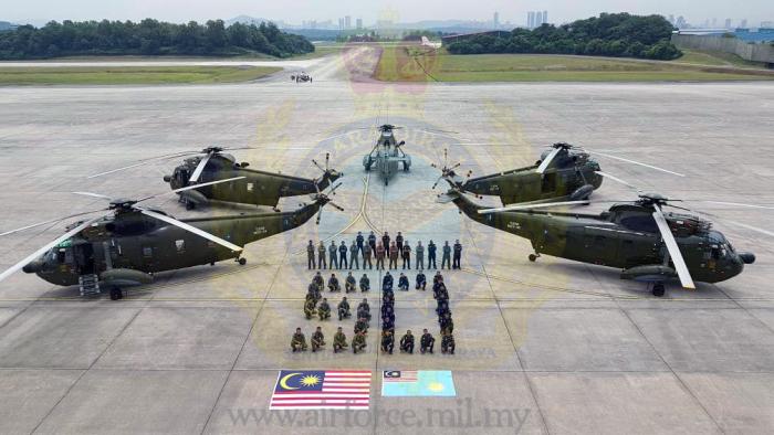 Sikorsky Nuri S-61 pilots and crew with the aircraft in RMAF livery