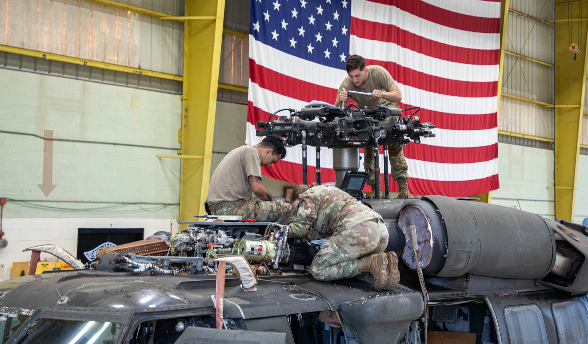 Maintainers perform repairs to a UH-60 Black Hawk at Wheeler Army Airfield, Hawaii, on March 4, 2021. The Network-enabled Analytics for Readiness initiative aims to improve aircraft readiness. (U.S. Army Photo/Sgt. Sarah D. Sangster) 